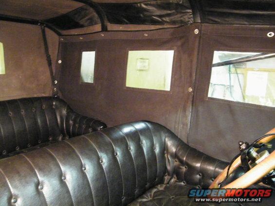 1915 Ford Model T interior with tufted leather seats and fabric side curtains