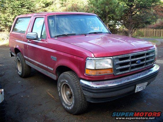 Red Ford Bronco, front quarter view. License plate reads 3JYE247