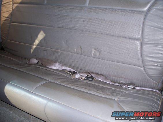 Gray vinyl rear bench seat with seatbelt buckle visible