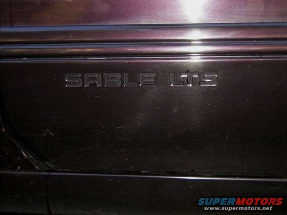 Close-up of 'SABLE LTS' emblem on a car's side panel