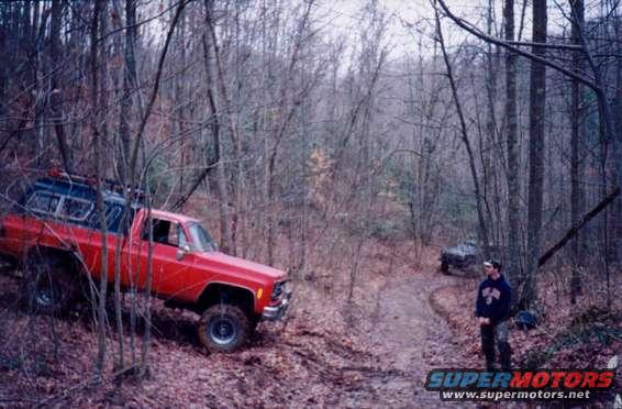 step_aside.jpg Big Red couldn't climb this hill, so he let me try it.  It's way steeper than you think and the picture is taken near the bottom. The wet leaves and mud were really gumming up the tires. I made it though, hooked two straps end to end and pulled the Chevy the rest the way up.