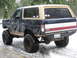 1989 Ford Bronco - This lifted Ford Bronco is equipped with large off-road tires and sits in a snowy environment.