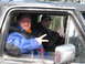 1989 Ford Bronco - Two men pose for a photo inside a vehicle, with trees visible in the background.