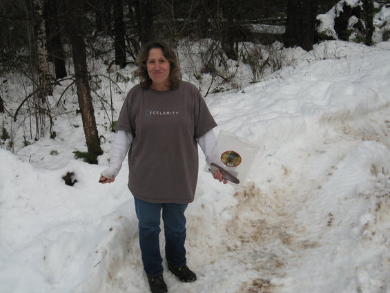 Woman in snowy woods wearing a t-shirt with 'CELERITY' logo