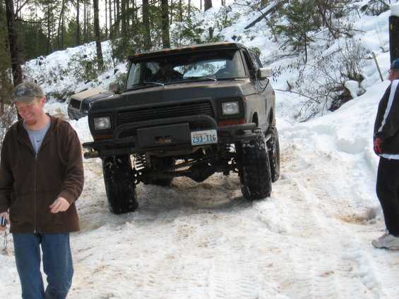 Black lifted Ford Bronco with a winch and license plate 293-TIG in the snow