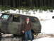 1989 Ford Bronco - Camouflaged Ford Bronco parked in a snowy forest scene with a man standing beside it.