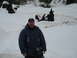 1989 Ford Bronco - A man poses for a photo in a snow-covered outdoor area with several large tree stumps visible in the background.