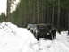 1989 Ford Bronco - Several off-road vehicles parked on a snow-covered forest road, with hoods open on the lead vehicle.