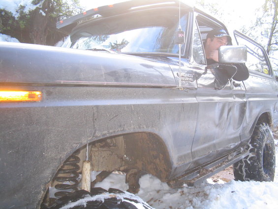 Ford Bronco in snow, driver visible