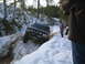 1989 Ford Bronco - A black 1989 Ford Bronco navigates a snowy, wooded trail, displaying "BIG BRONCOS 4x4 CLUB" on its windshield.