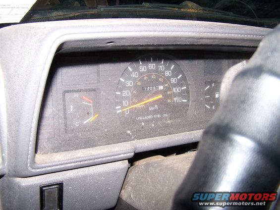 Speedometer reads 14297 miles, temp gauge is near C, fuel gauge is near E