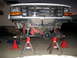 1996 Ford Bronco - Front suspension of a 1996 Ford Bronco is raised on jack stands for maintenance.