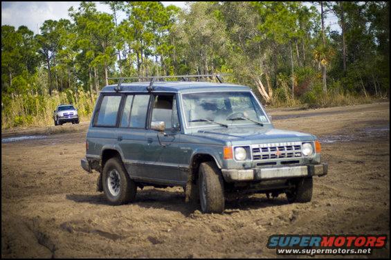 1987 Mitsubishi Montero parked on dirt with another SUV in the background