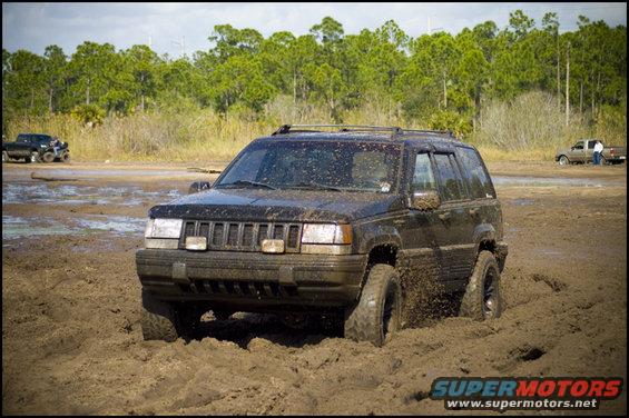 Black 1996 Jeep Grand Cherokee stuck in mud, front view