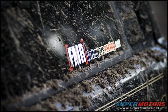 Mud-covered black truck side with FMR fortmyersracing.net sticker