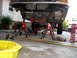 1996 Ford Bronco - The front suspension of a vehicle is disassembled and supported by jack stands, with tools and parts scattered around.