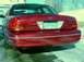 1999 Ford Crown Victoria - Rear view of a red Ford Crown Victoria with a license plate and chrome trim.