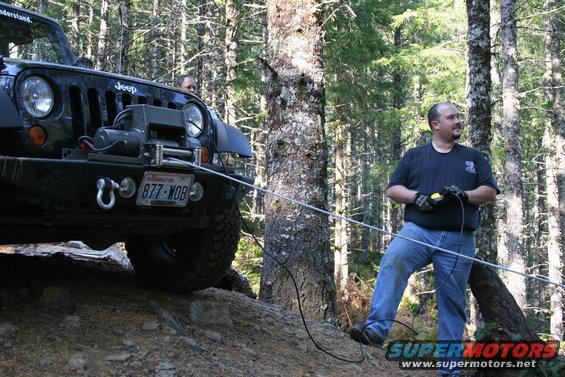 Running the winch off of the front of the Jeep which I had anchored.  