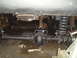 1992 Ford Bronco - Underside view of a vehicle's rear axle and suspension system, showing mechanical components.