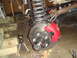 1992 Ford Bronco - A vehicle's suspension and brake system are shown in detail, with a red caliper and hub assembly as the focal point.