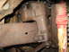 1978 Ford Bronco - Underside view of heavily rusted steering and suspension parts, likely from an older vehicle.
