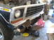 1978 Ford Bronco - The front end of a 1978 Ford Bronco is shown with its grille and bumper removed for repair.