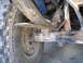 1978 Ford Bronco - This image shows the rear suspension and tire of a vehicle, focusing on the leaf springs and shock absorber.