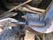 1978 Ford Bronco - Vice grips are used to work on a bolt on the undercarriage of a vehicle.