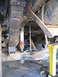 1978 Ford Bronco - The underside of a vehicle is shown with its suspension components and a jack supporting it.