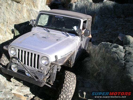 Silver Jeep Wrangler Rubicon on rocky terrain