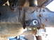 1978 Ford Bronco - Detail of a vehicle's suspension system, showing a rusty bracket and mounting hardware.