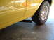 1978 Ford Ranchero - Close-up view of the side panel and rear wheel of a yellow vehicle, a BFGoodrich tire.