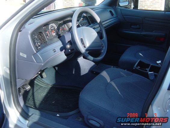 Interior of a 2000 Ford Crown Victoria showing dashboard, steering wheel, and seats
