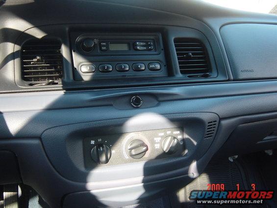 Interior shot of a car's dashboard with radio, air vents, and climate controls visible