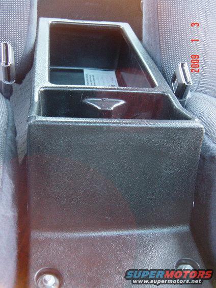 Interior shot of a car's center console with a seatbelt buckle visible on the right