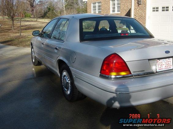 Silver 2000 Ford Crown Victoria sedan, rear 3/4 view, chrome trim, North Carolina license plate YSR-1661
