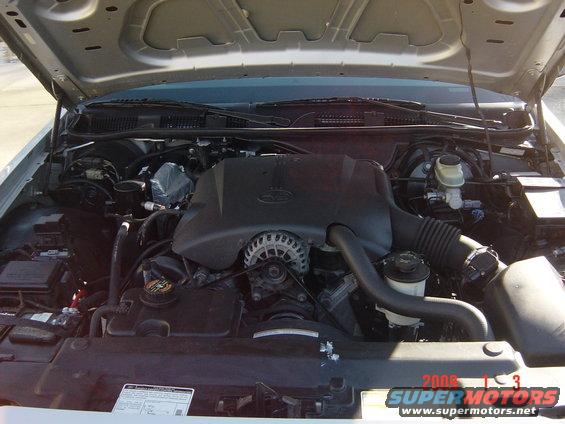 2000 Ford Crown Victoria engine bay with visible 'Ford' logo on engine cover