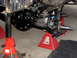 1996 Ford Bronco - Front suspension and differential assembly supported by red jack stands, showing the brake rotor and spindle.