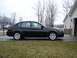 2008 Subaru Impreza - Side profile of a black 2008 Subaru Impreza sedan parked in a driveway.
