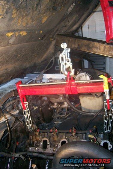 Engine hoist supporting engine block during repair