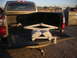 1991 Ford Bronco - A pickup truck bed is shown with a jack and wheel chocks loaded inside.