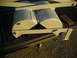 1991 Ford Bronco - Dual exhaust tips and their mounting hardware are shown in a truck bed.