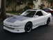 1994 Ford Probe - A white 1994 Ford Probe GT with a grey hood and aftermarket wheels is parked outside.