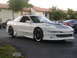 1994 Ford Probe - A white 1994 Ford Probe is parked in a lot with other vehicles visible.