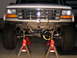 1996 Ford Bronco - Front suspension of a 1996 Ford Bronco, raised on jack stands for maintenance.