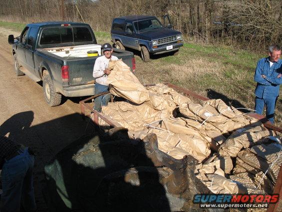 This is how the trees come from the nursery (this is a tiny portion of an order).  The man in denim is not one of us, he is the guy we're planting the trees for. 
