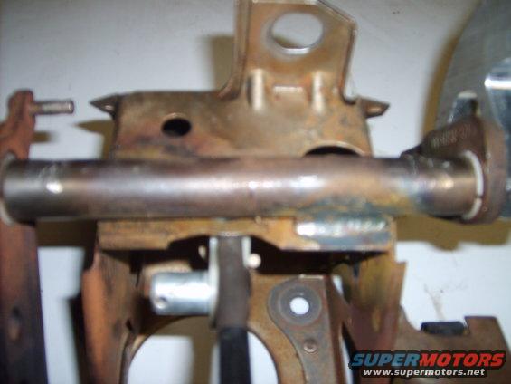 close-up of rusty metal bracket assembly with a horizontal pipe
