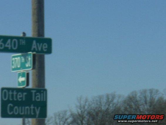 Street signs for 640th Ave, 370th St, and Otter Tail County