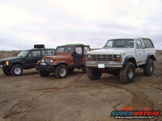 White 1983 Ford Bronco 3/4 front view with lifted suspension and off-road tires