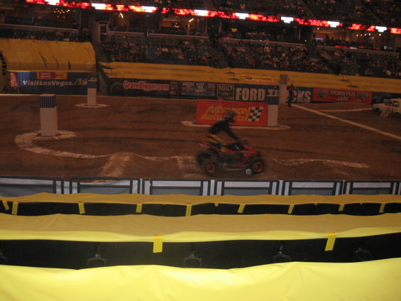 Red ATV with rider on dirt track